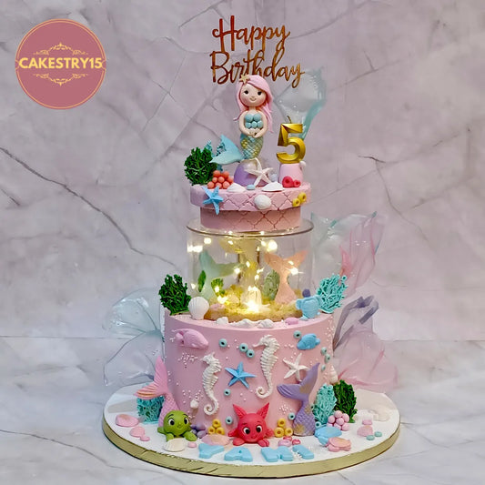 Eggless mermaid kids birthday cake with spacer and rotator design for a luxury theme cake Noida celebration.