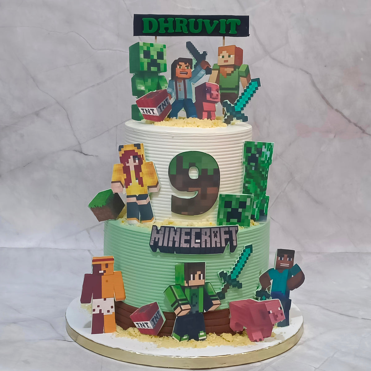 Minecraft theme birthday cake decorated with game characters, a sword and TNT-inspired elements for a boy’s 9th birthday.
