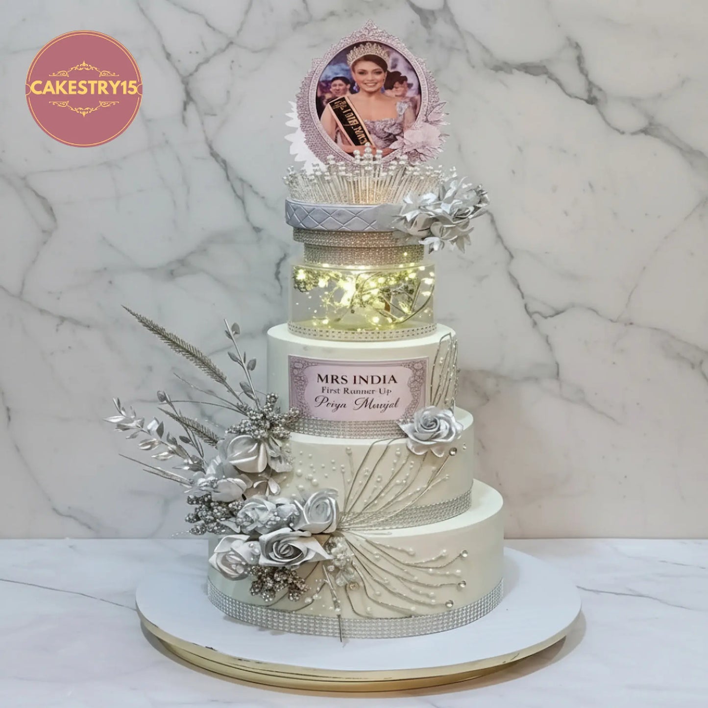 Mrs India winner 3 tier custom cake with coloured ganache, crown and illuminated spacer details.