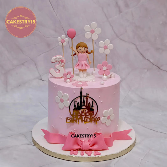 2kg Black Forest doll theme birthday cake with girl figurine topper and white flowers from Cakestry15 Noida