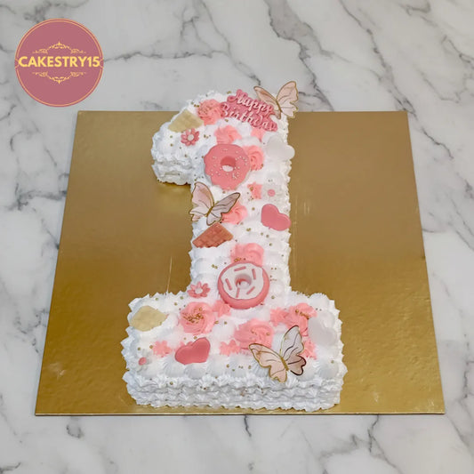 Number 1 kids birthday cake with fondant hearts, donuts and butterflies, from an eggless cakes bakery offering a theme cake Noida.