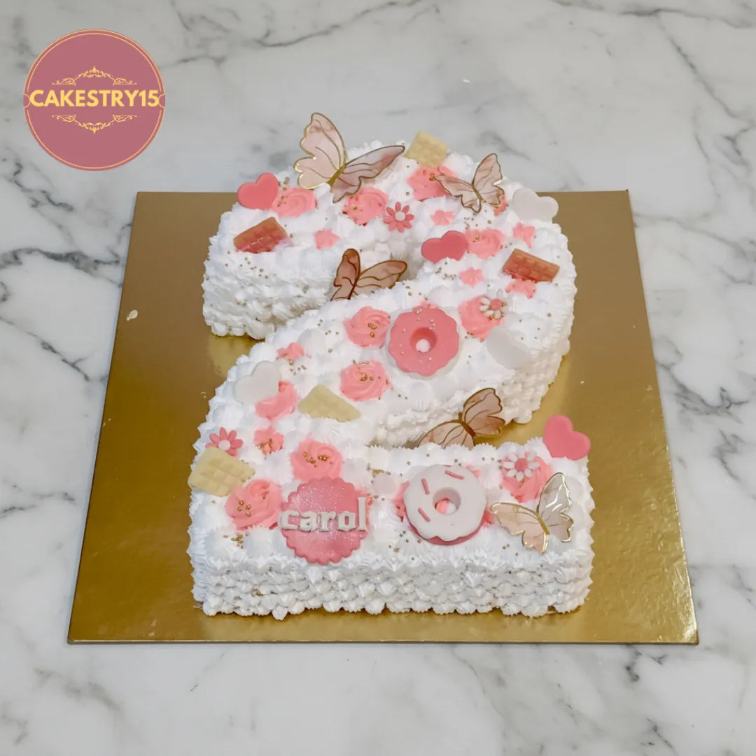 Number 2 kids birthday cake with hearts, donuts, chocolates and butterflies, available as a theme cake Noida from an eggless cakes bakery.