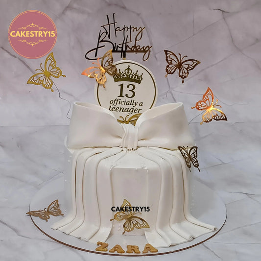 1kg eggless truffle officially teenager cake with white bow and golden butterflies by Cakestry15 Noida