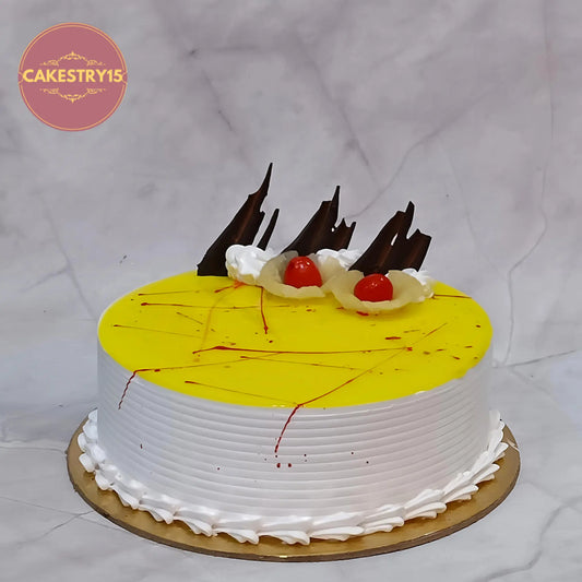 Eggless pineapple kids birthday cake with cherry and chocolate garnishing, a classic theme cake Noida option from premium eggless cakes collection