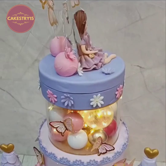 Rotating view of a princess doll kids birthday cake with castle details and butterflies, premium theme cake Noida by Cakestry15 featuring handcrafted eggless cakes.