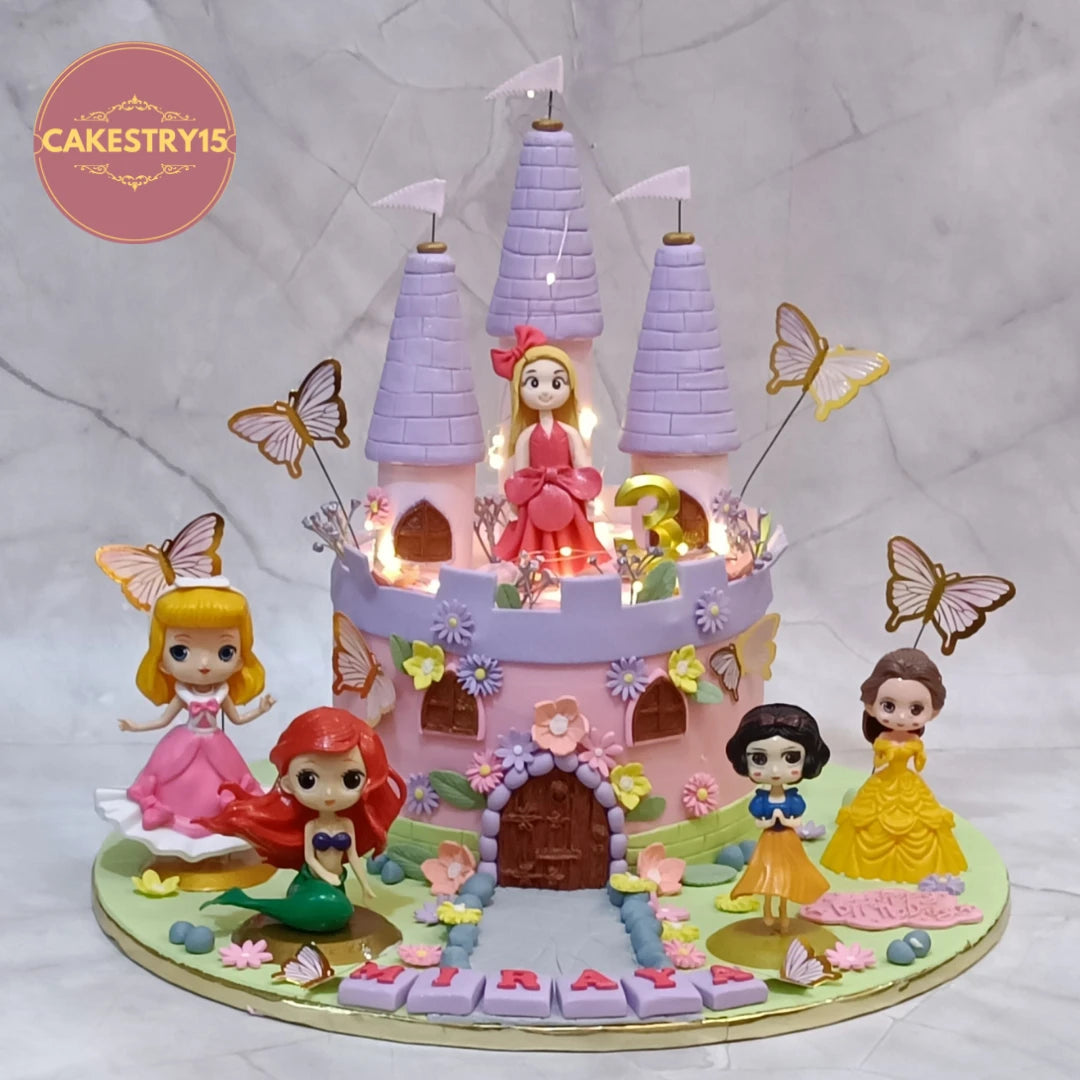 Princess and castle themed kids birthday cake with princess figures and butterflies, a premium theme cake Noida families choose from Cakestry15 eggless cakes collection.