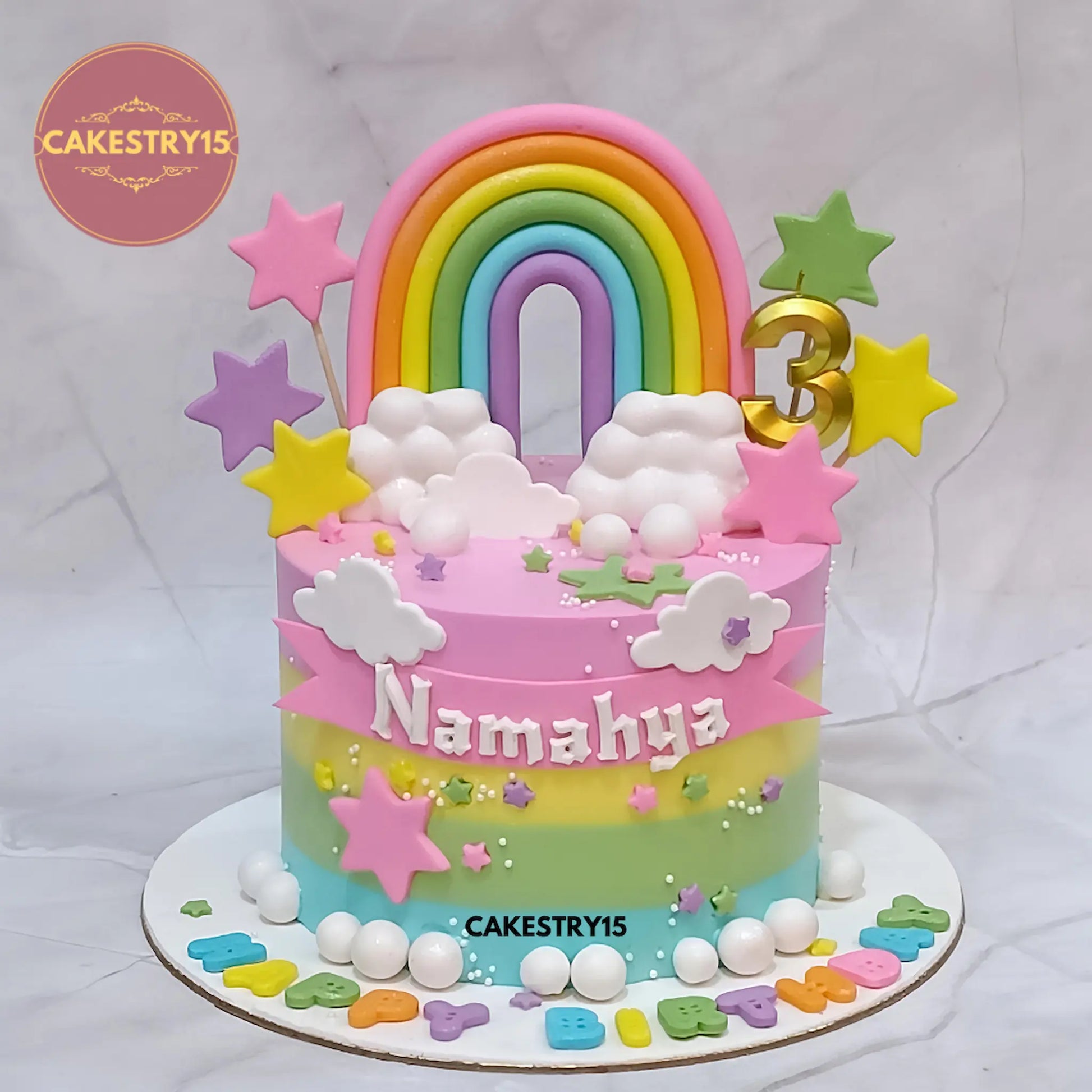 Eggless rainbow kids birthday cake with fondant rainbow, clouds and stars for a theme cake Noida celebration.
