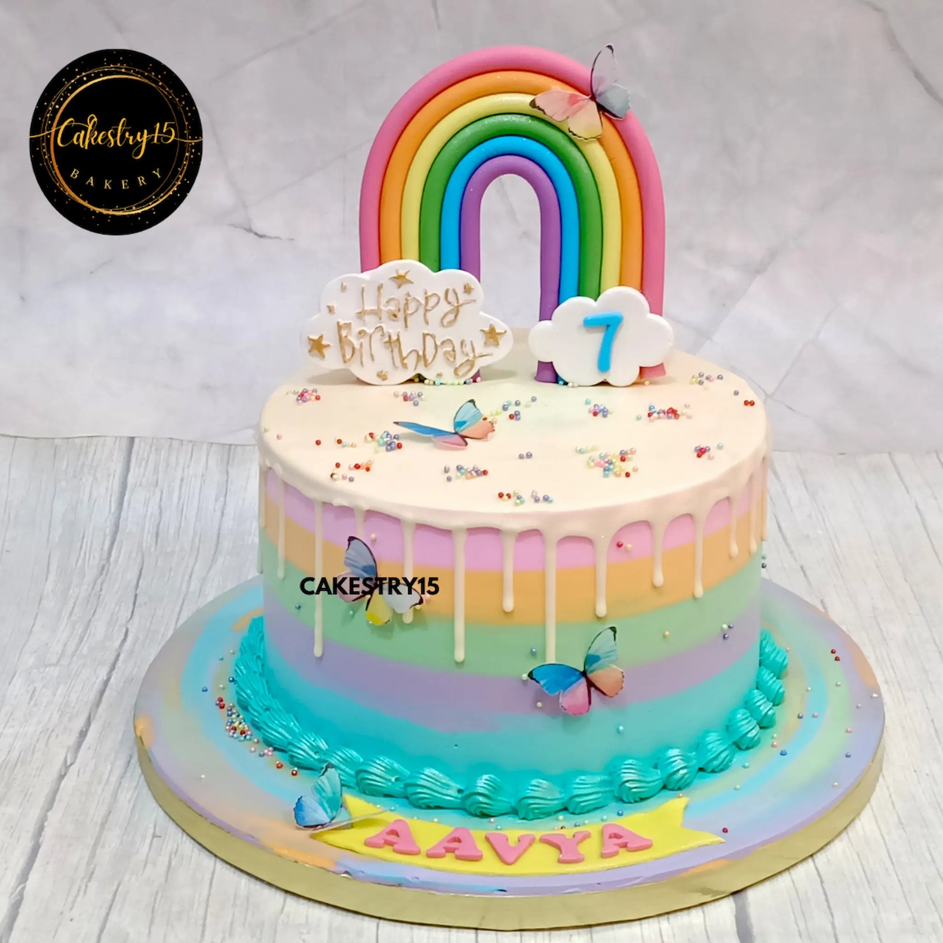 Rainbow kids birthday cake with chocolate base and white drip, theme cake Noida from eggless cakes collection