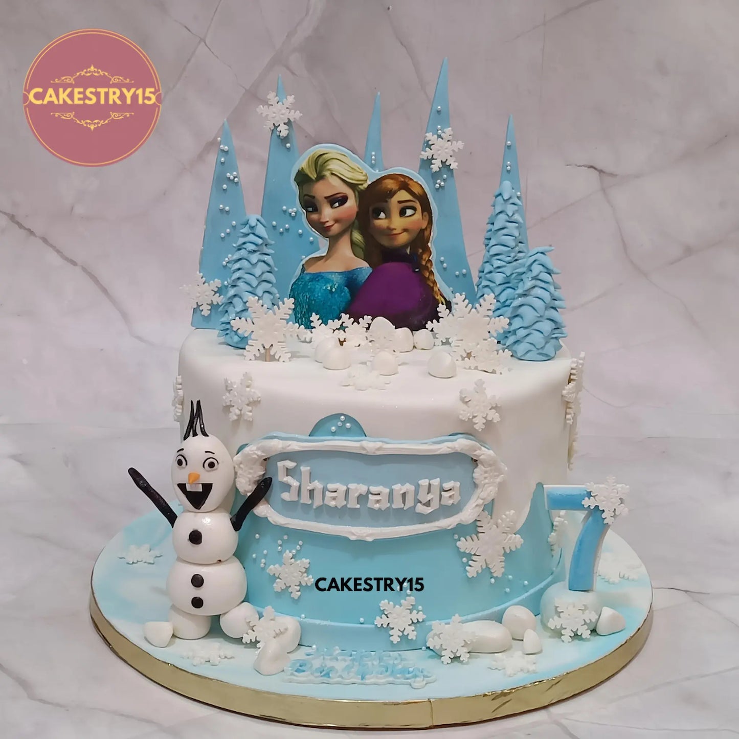 2kg chocolate Frozen theme birthday cake with princess pictures, Olaf, and white fondant mountain design from Cakestry15
