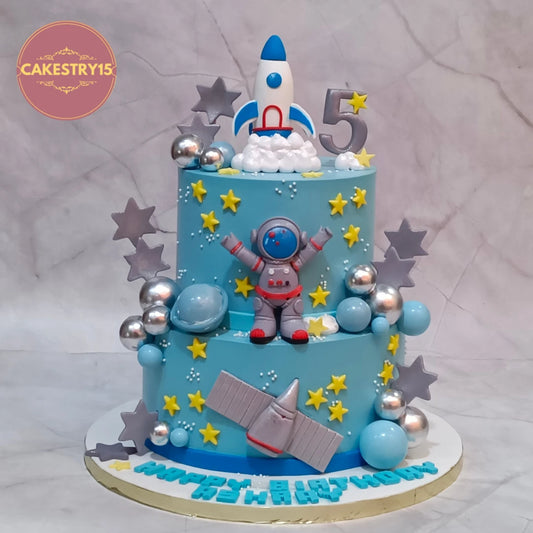 Space Astronaut kids birthday cake handcrafted with fondant astronaut, rockets and satellite as a premium theme cake Noida using fresh eggless cakes.