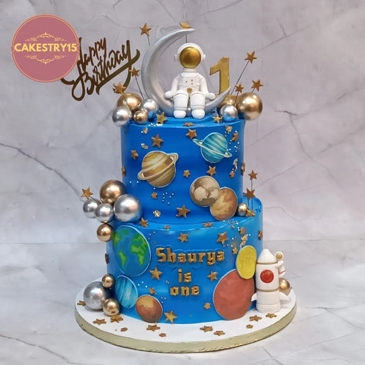 Eggless space astronaut kids birthday cake with planets and rocket for first birthday celebration in Noida