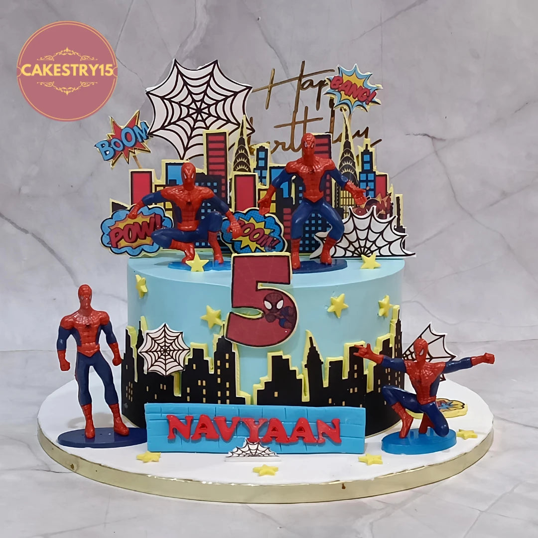 Premium eggless Spiderman kids birthday cake with superhero toys, city buildings and spider web design, handcrafted as a custom theme cake in Noida.