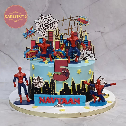 Premium eggless Spiderman kids birthday cake with superhero toys, city buildings and spider web design, handcrafted as a custom theme cake in Noida.