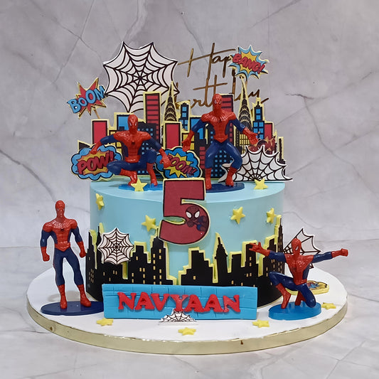 Premium eggless Spiderman kids birthday cake with superhero toys, city buildings and spider web design, handcrafted as a custom theme cake in Noida.