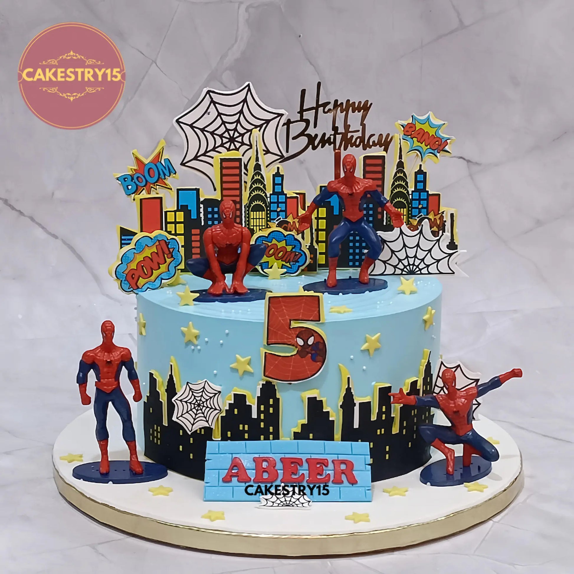 Eggless Spiderman theme kids birthday cake with superhero toys and city design for a 5th birthday in Noida by Cakestry15