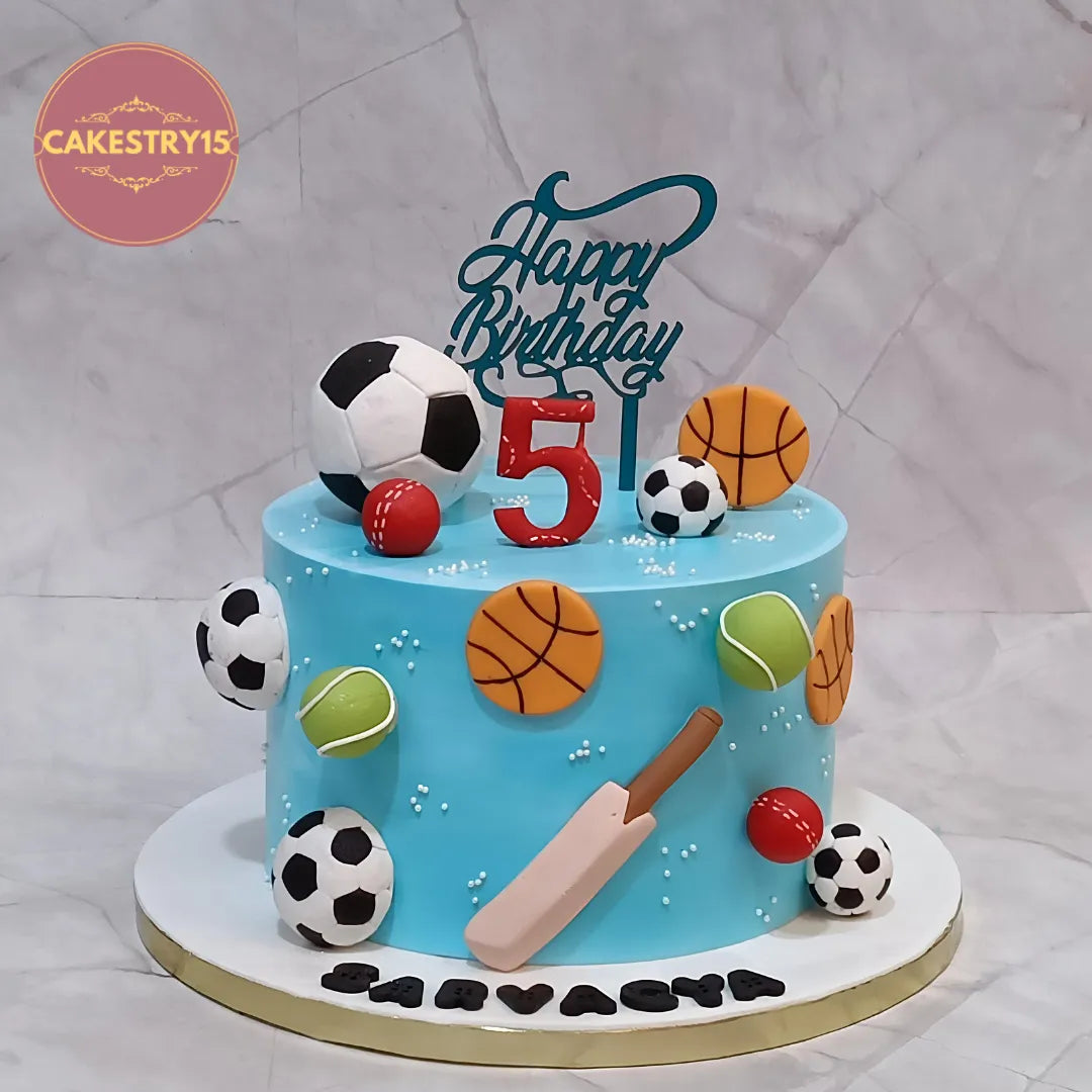 Eggless sports theme kids birthday cake in Noida with football, cricket and basketball elements for boys birthday celebrations.