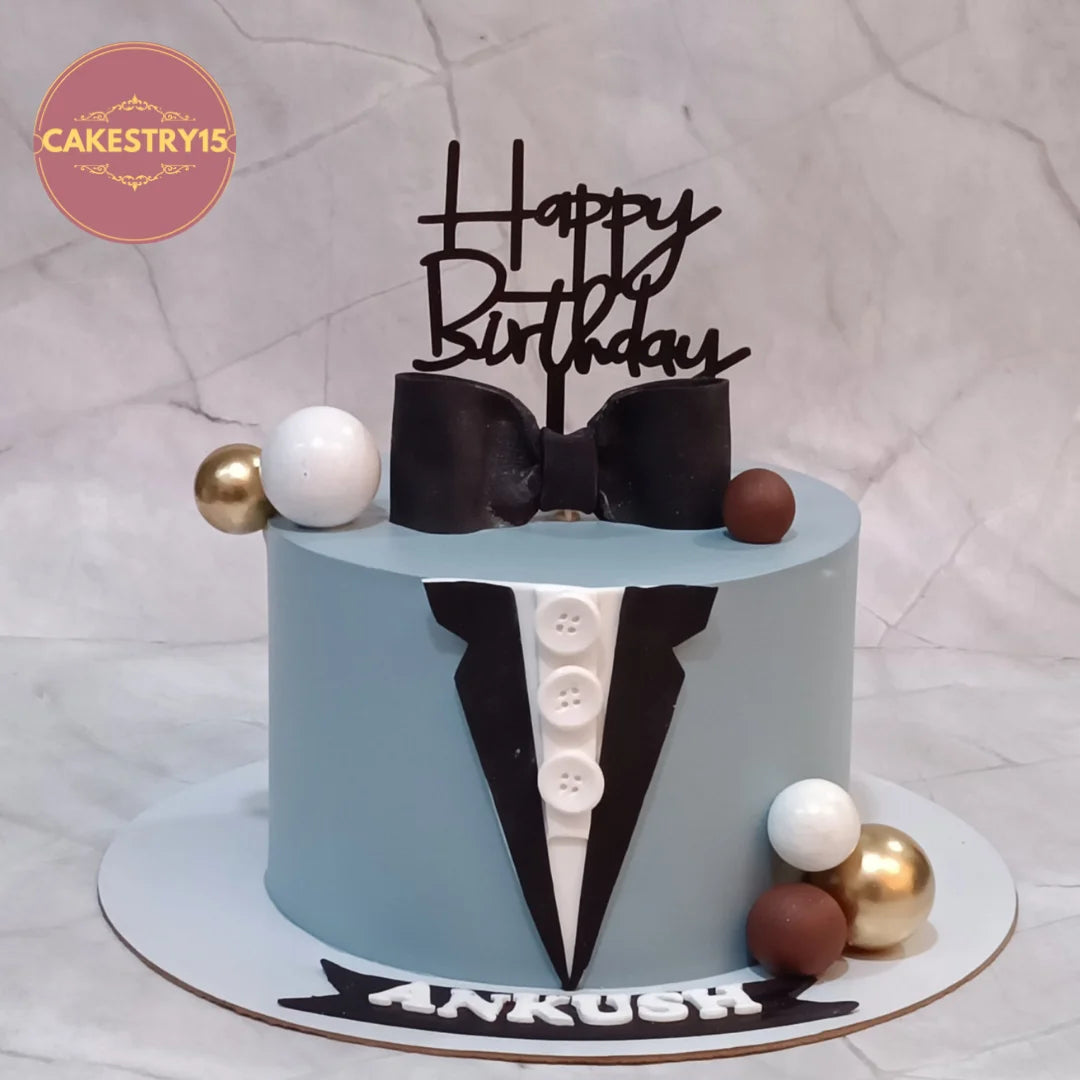 Suit theme kids birthday cake with fondant details from an eggless cakes bakery offering a theme cake Noida.