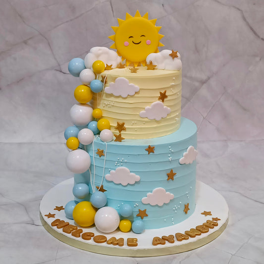 Sunshine theme 2-tier welcome baby cake with sun, clouds, stars and faux balls.