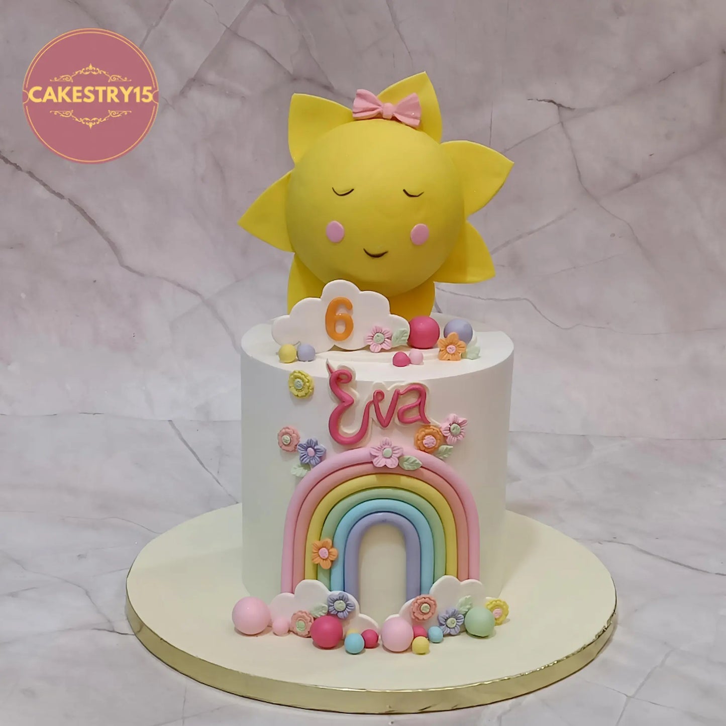 Sunshine theme eggless kids birthday cake in Noida with sun topper, rainbow, clouds and fondant flowers by Cakestry15