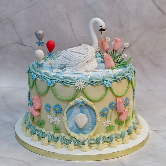 Elegant swan theme birthday cake with white ganache, tulips and floral details from our eggless cakes collection, available as a theme cake in Noida.