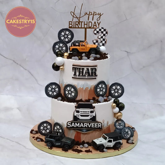 Eggless Thar theme kids birthday cake in Noida with car toys and fondant pebbles for a stylish 3rd birthday celebration.