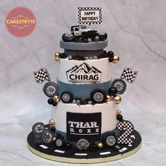 Thar theme 2nd birthday cake with rotating jeep toy, fondant road, wheels and flags eggless cake in Noida