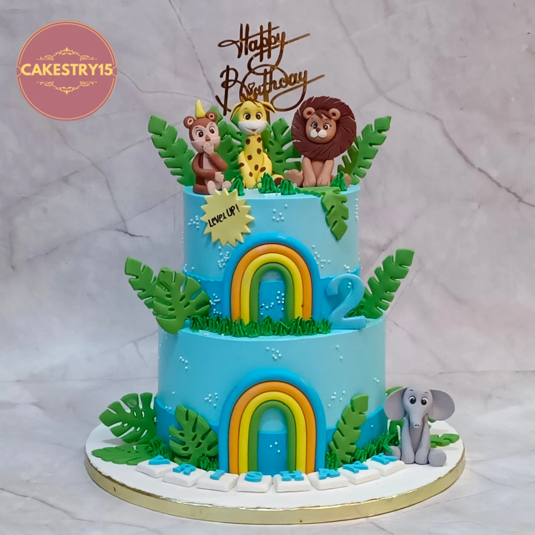 The Great Jungle Adventure kids birthday cake with fondant lion, giraffe, monkey, elephant and rainbows, handcrafted as a theme cake Noida using premium eggless cakes.
