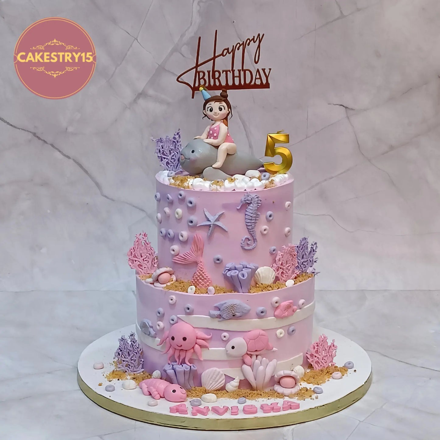 Under sea theme kids cake for 5th birthday Anvisha with dolphin girl topper and ocean elements in eggless choco vanilla flavour Noida