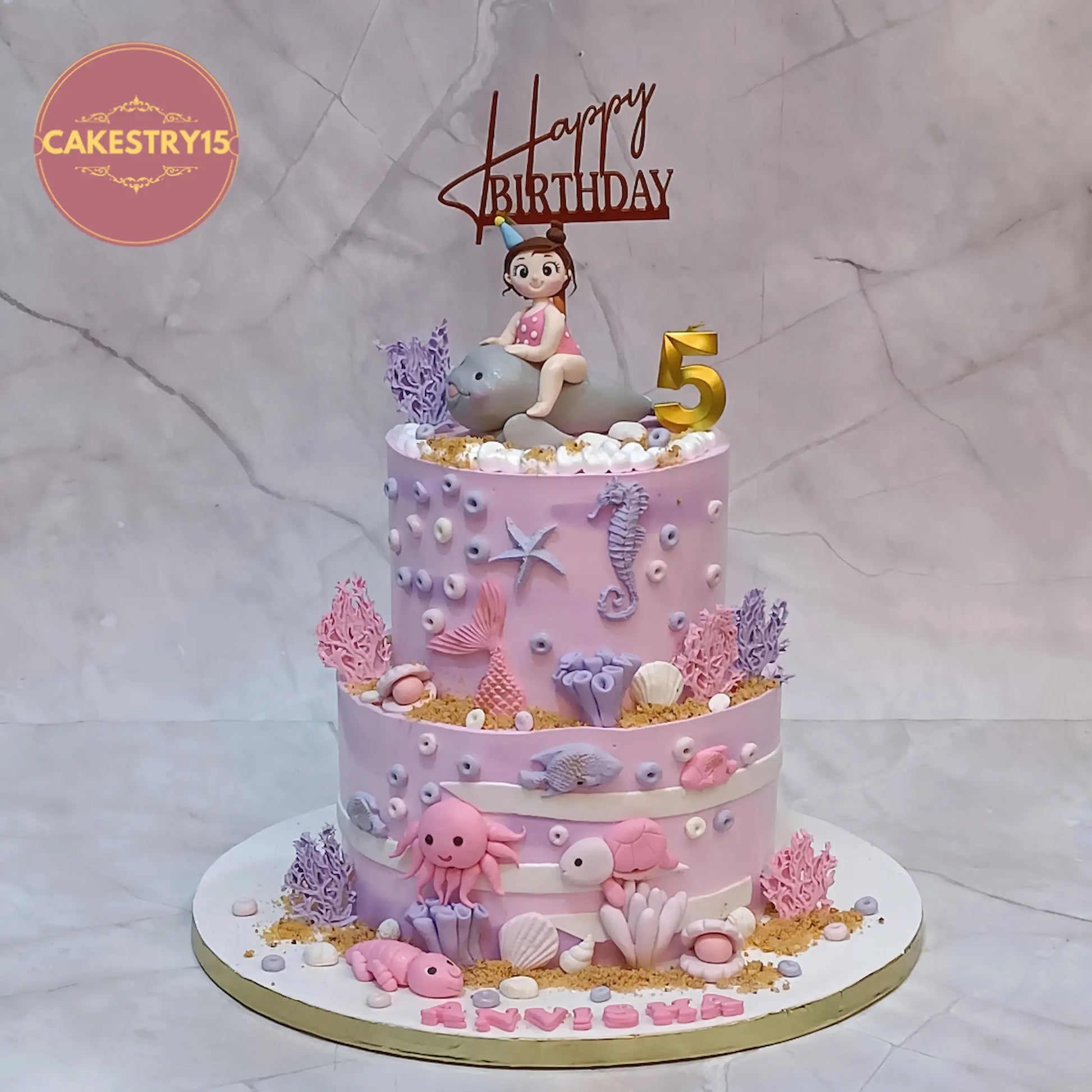 Under sea theme kids cake for 5th birthday Anvisha with dolphin girl topper and ocean elements in eggless choco vanilla flavour Noida