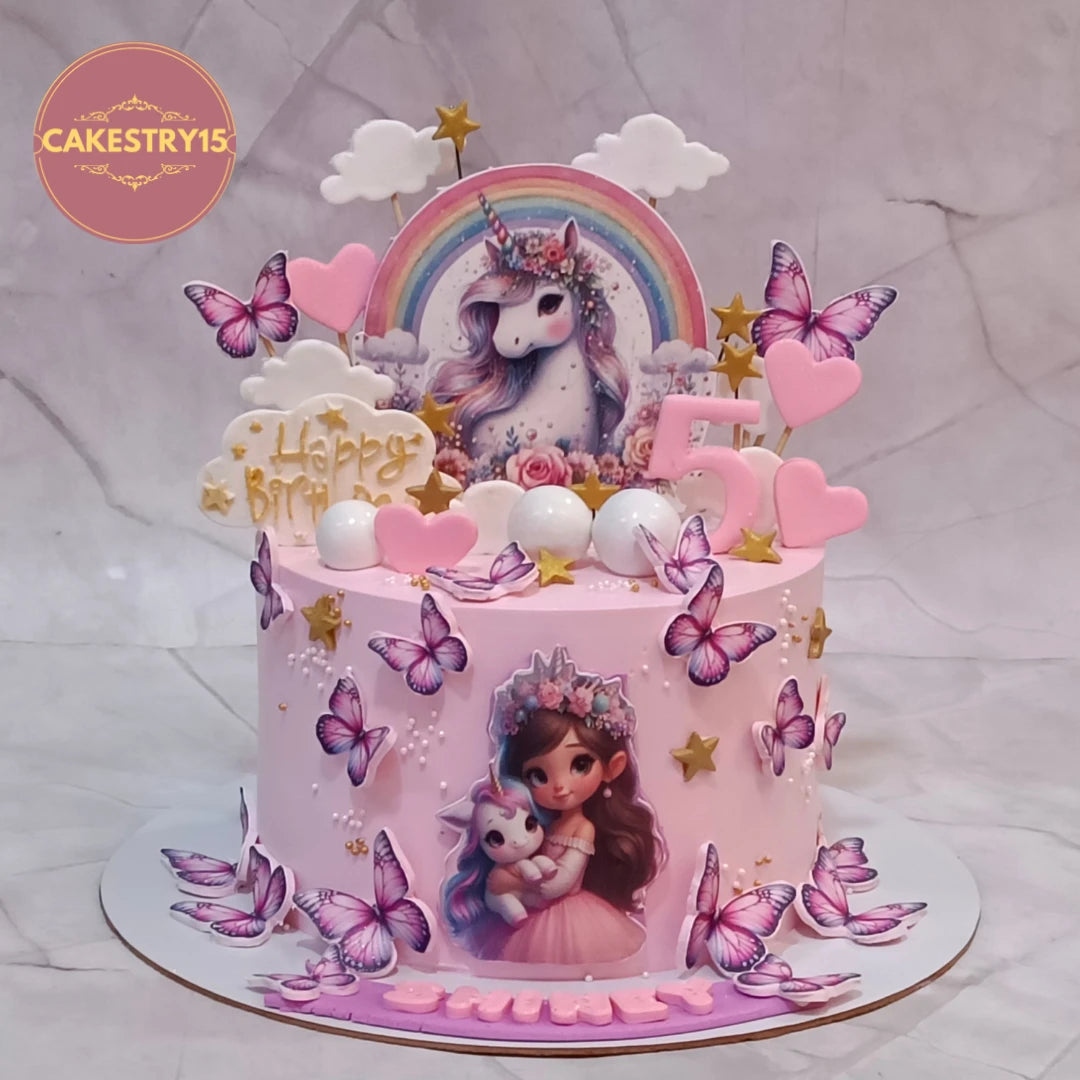Eggless unicorn 5th kids birthday cake with edible unicorn image, butterflies and fondant decorations, handcrafted as a premium theme cake in Noida.