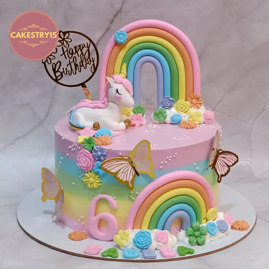 Eggless unicorn castle kids birthday cake with rainbow colours and butterflies, premium theme cake Noida for girls celebrations.