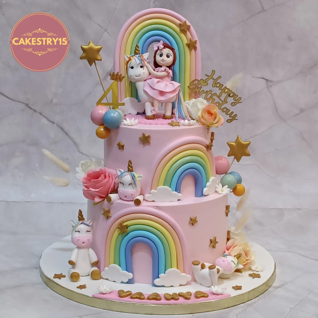 Premium unicorn theme kids birthday cake and welcome baby cake featuring rainbows and a girl figurine, handcrafted eggless cakes and theme cake Noida.
