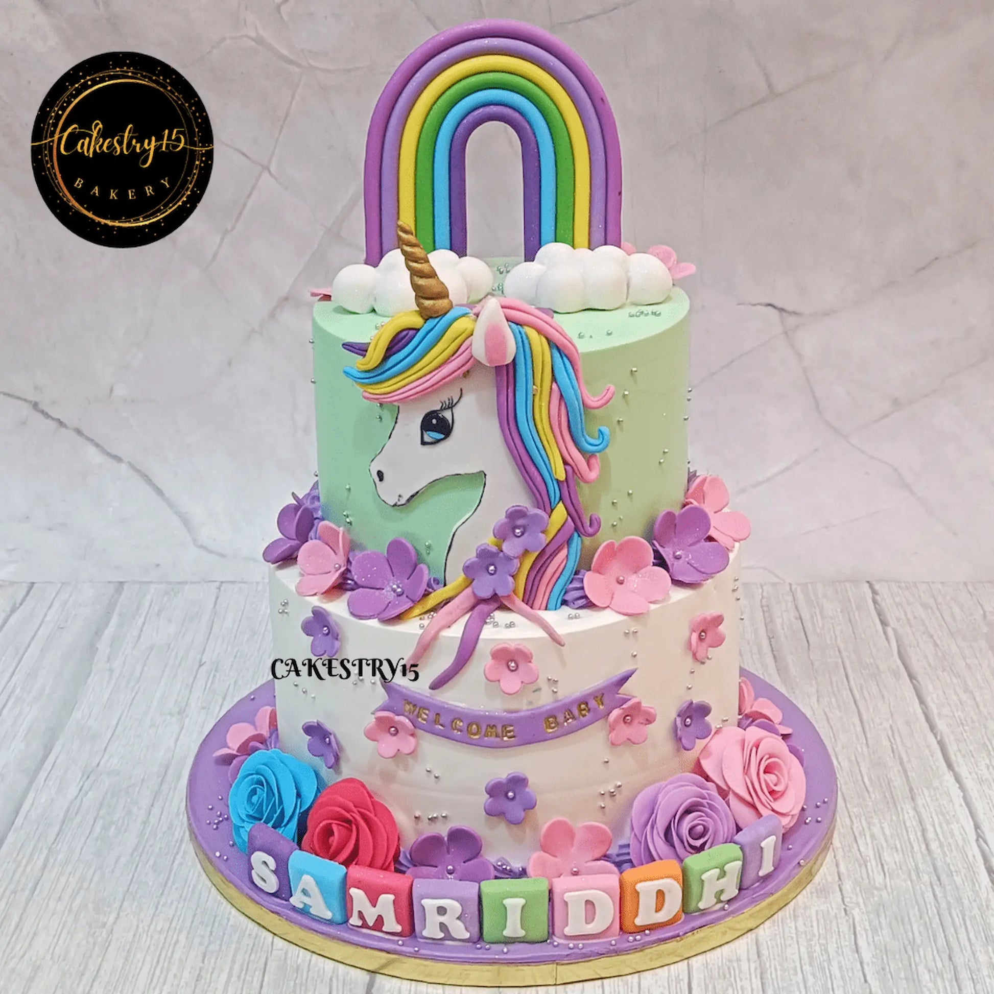 Eggless unicorn welcome baby cake 3kg two tier blueberry theme cake in Noida by Cakestry15