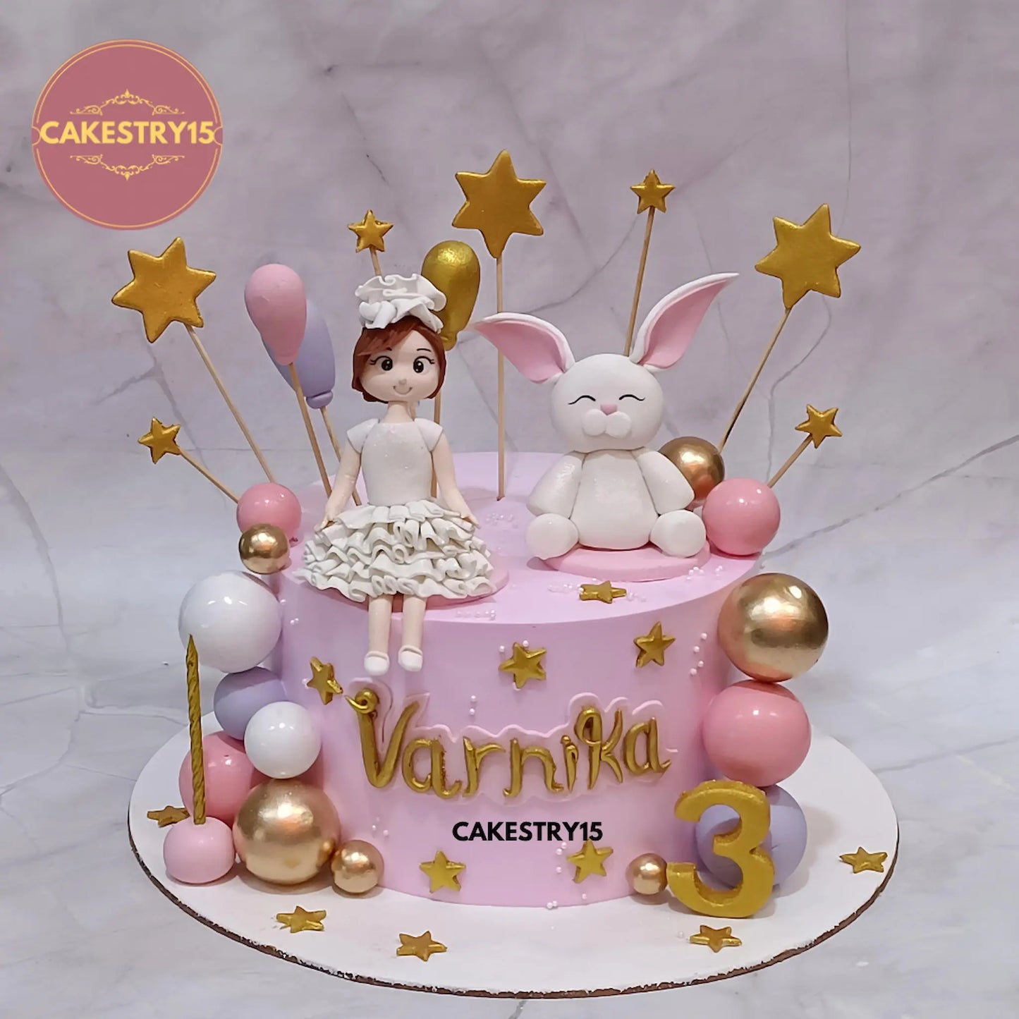 2kg chocolate cake for Varnika’s 3rd birthday with girl and rabbit figurines, balloons, stars, and multi-color balls from Cakestry15