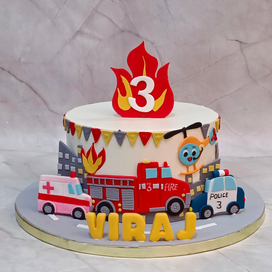 Vehicle theme kids birthday cake with fire brigade, ambulance and police car, available as a theme cake Noida from an eggless cakes bakery.