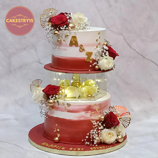 Eggless wedding celebration cake with floral spacer in ivory and maroon shades by Cakestry15 Noida