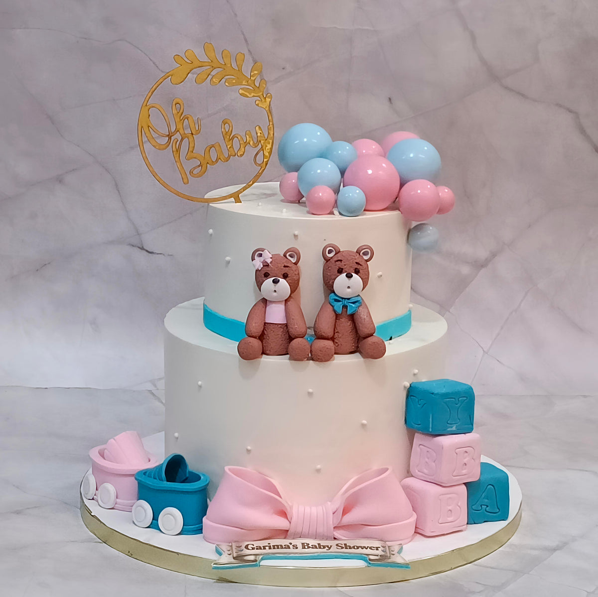 Welcome Baby kids celebration cake with teddy figures, prams, ABC blocks and faux balls, a two-tier eggless theme cake available in Noida.