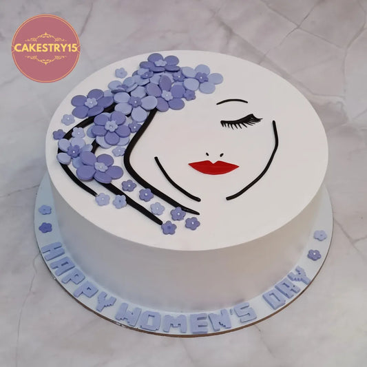 Elegant women’s day birthday cake inspired theme cake Noida design with floral detailing made as premium eggless cakes.
