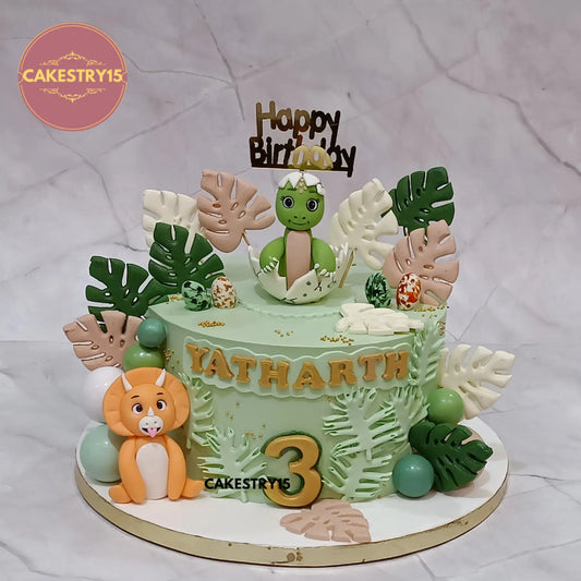 2kg chocolate dino theme birthday cake for Yatharth with baby dino topper and green leaves, from Cakestry15 Noida