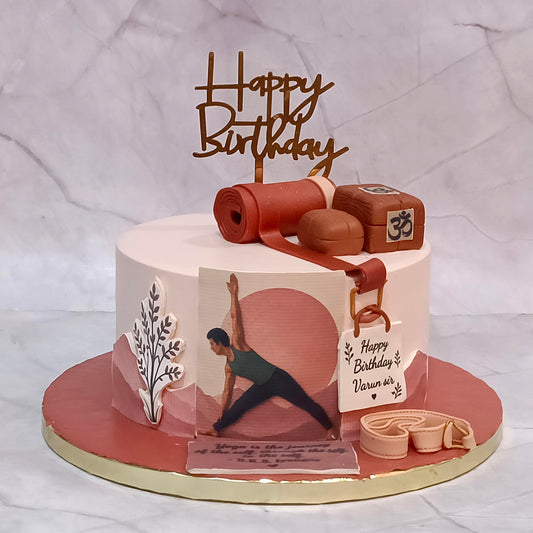 Yoga coach birthday cake with edible images of a person doing yoga, yoga mats and other yoga-related materials.